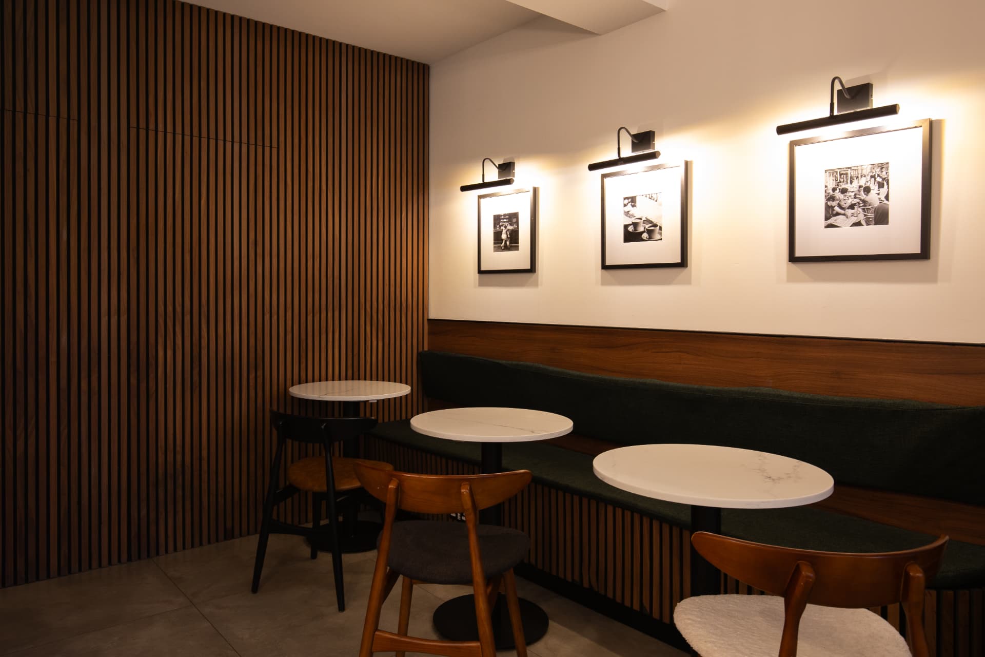 Cafe seating with fluted timber wall and framed photos